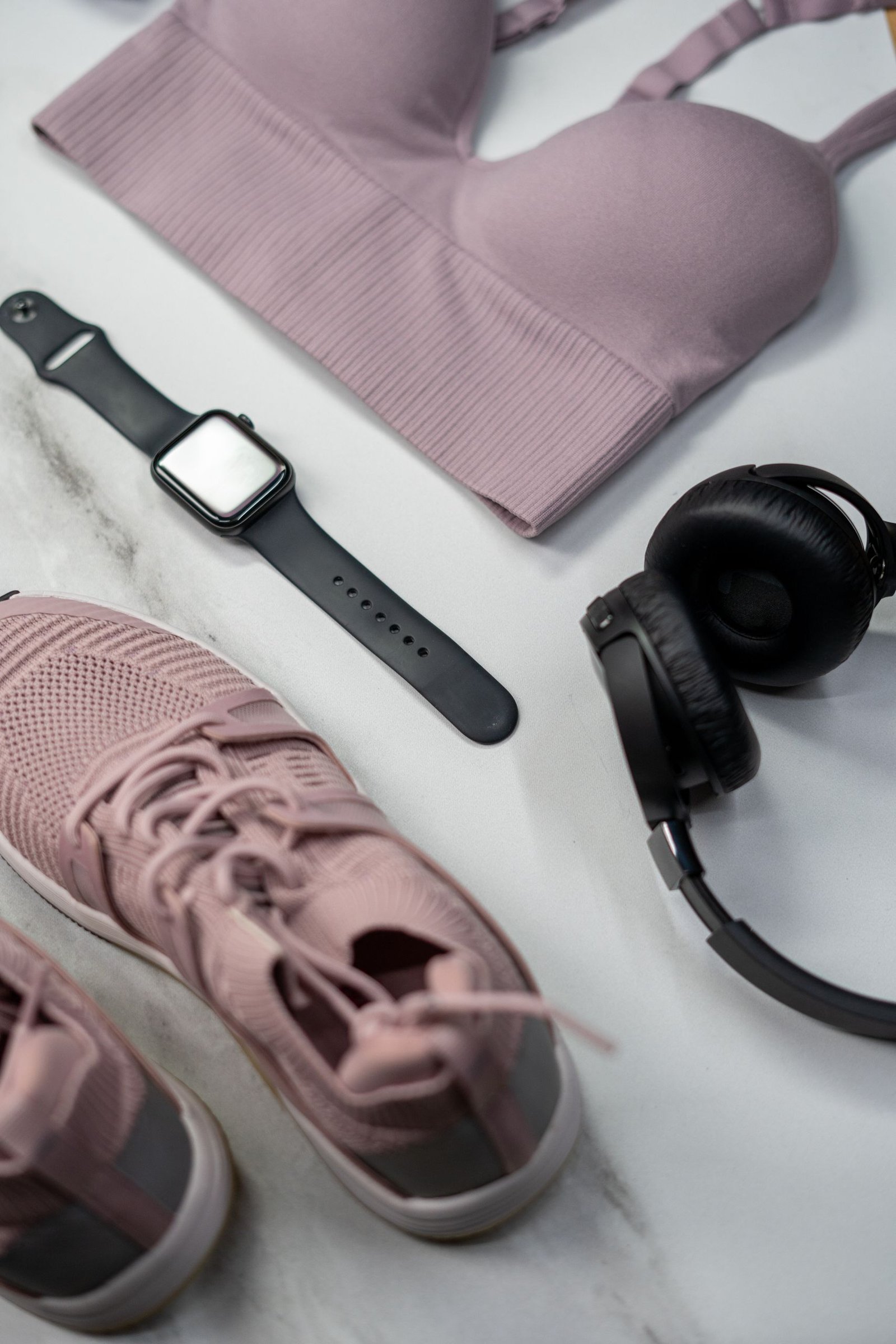 בית Flat lay of gym essentials with pink sportswear and smartwatch.